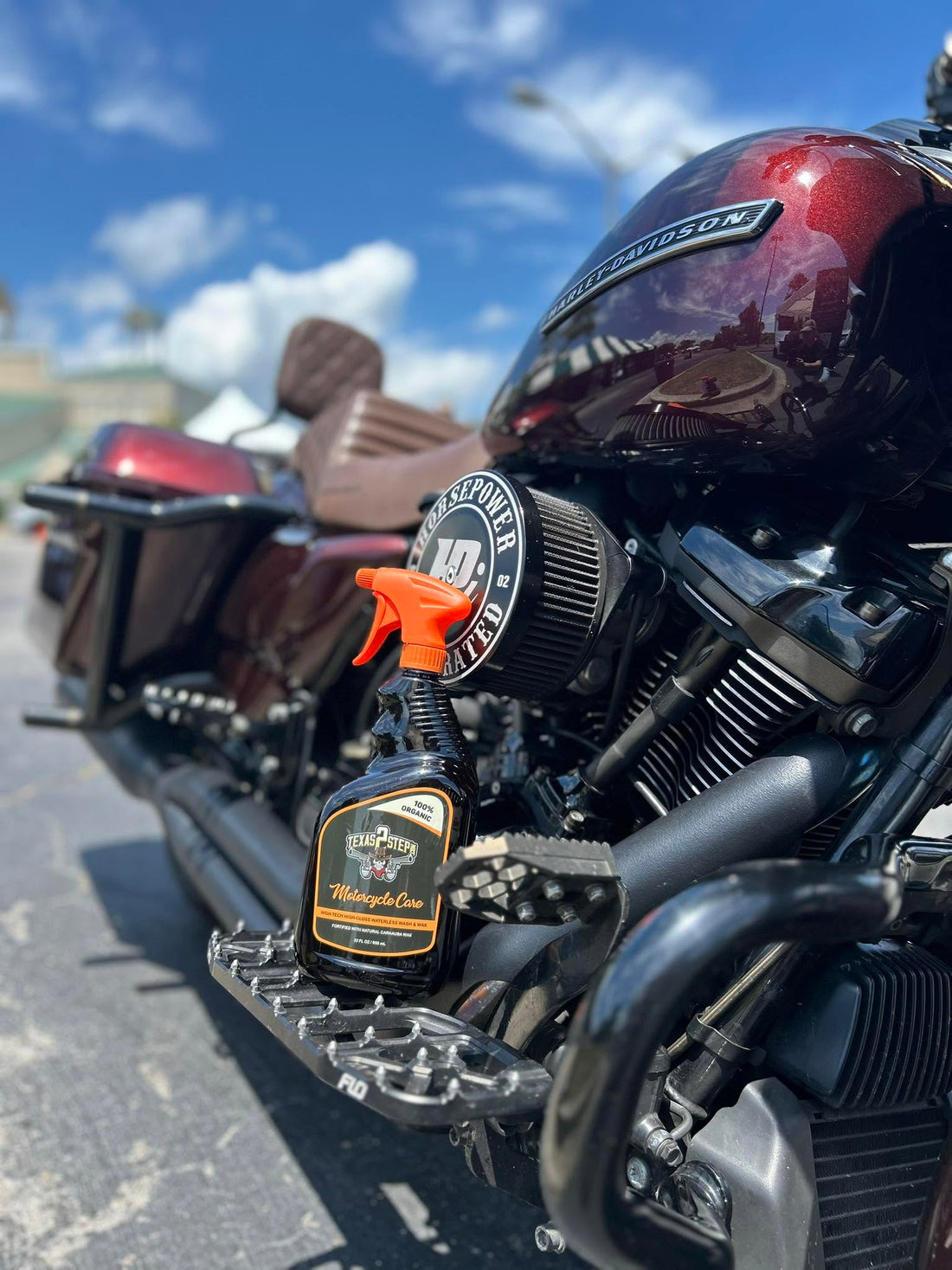 Texas 2 Step Motorcycle Care spray being used to clean a motorcycle without a hose